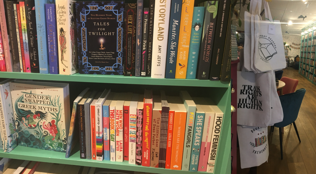 Image of book shelf with inclusive titles on left and image of inclusive tote bags on right with phrases such as "Trans Rights are Human Rights" to be seen
