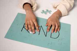 child s hand on a puzzle