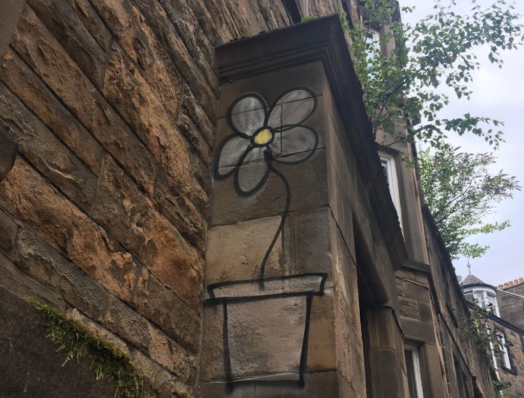 Graffiti daisy on a brick wall
